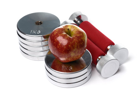Barbells and apple isolated on white backgroundの写真素材