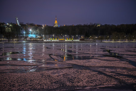 Night view of winter river in ice and embankment near Moscow university, Russiaの写真素材