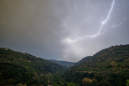 Lightning in the sky over hills