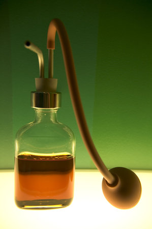 Small bottles with colored liquid in a colored laboratory.