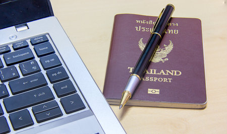 Pen for writing Passport for travel and computer for typingの写真素材