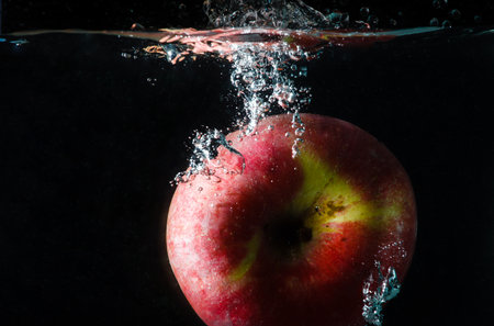 the fruit splash is apple in the waterの写真素材