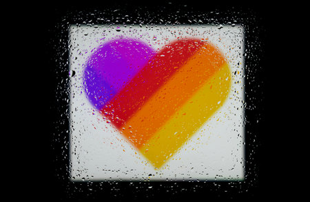 Heart with multi-colored stripes on a black background. Abstract photo of a heart with rainbow...