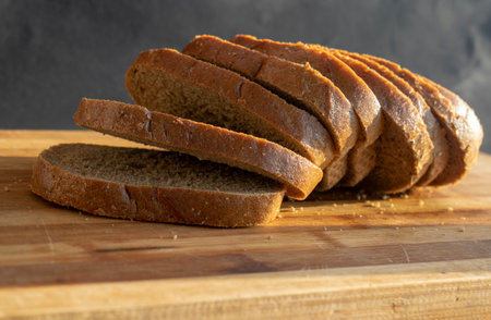 Pieces of black bread close-up on a wooden board. Wheat homemade bread