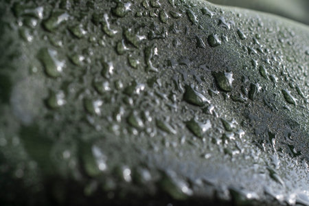 Water drops on the fabric. Water drops on green background. Condensate. Water drops background.Luxury green backgroundの写真素材
