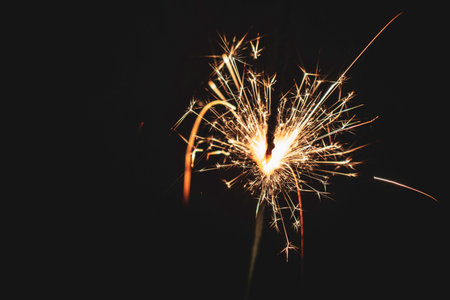 Burning christmas sparkler isolated on black background. Bengalの写真素材