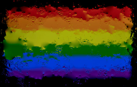 Drops of water on rainbow flag background. Shallow depth of field. Selective focus. Toned.の写真素材