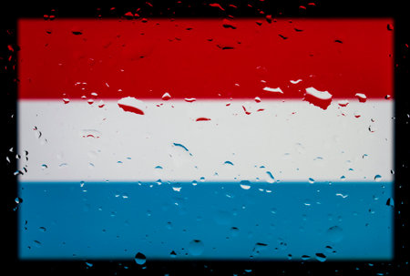 Drops of water on Luxembourg flag background. Shallow depth of field. Selective focus. Toned.の写真素材