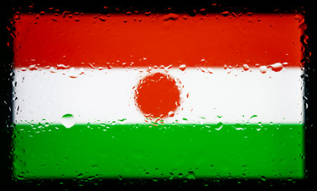 Drops of water on Niger flag background. Shallow depth of field. Selective focus. Toned.の写真素材