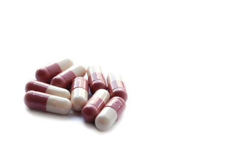 Closed up medicine Pink capsule isolated on white background