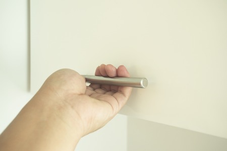 Closed up man hand open the wood box or cabinet doorの写真素材