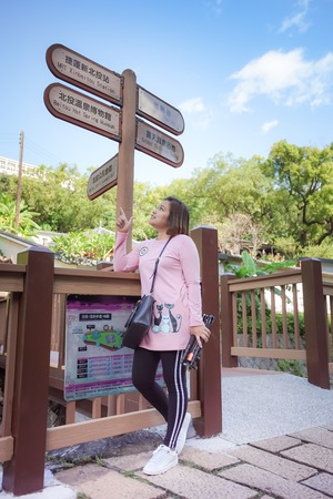 Taipei, Taiwan - November 24, 2018: Asian woman tourist approaches to the infomation sign, Beitou Park, Taipei, Taiwan.のeditorial素材
