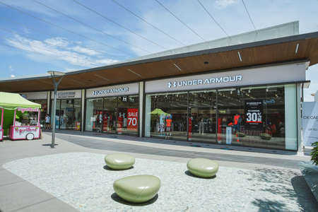 Samut Prakan, Thailand - July 28, 2020: Under Armour shop in Siam Premium Outlets Bangkok. Under Armour, Inc. is an American company that manufactures footwear, sports and casual apparel.のeditorial素材