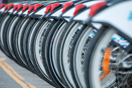 Many bicycles standing alone in the asphalt path. The symbol of sport and healthy lifestyleの写真素材