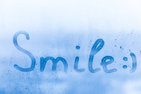 Inscription smile on window glassの写真素材