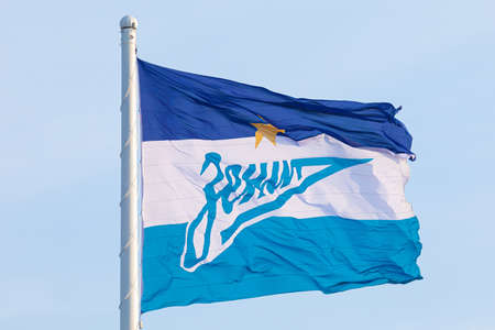 Zenit Arena in Saint Petersburg / Russia - October 03 2020: Official flag of football or soccer club Zenit on background of blue cloudy sky. Inscription in Russian means Zenit the name of football clubのeditorial素材