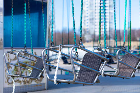 Vivid, colorful and bright urban background, scenery or view of modern carousel or roundabout with...