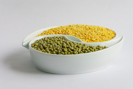 Different types of Multicolored beans in white ceramics bowl