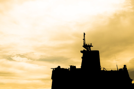 Silhouette of war ship in the seaの写真素材