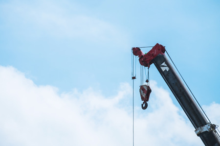 A large crane is working on blue sky backgroundの写真素材