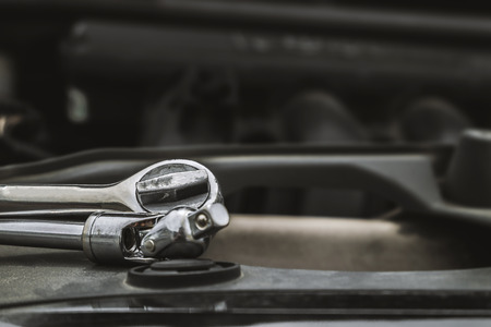 wrench ratchet placed in front of the engine Prepare for engine maintenance.の写真素材