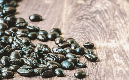 Coffee bean pour on wooden tableの写真素材