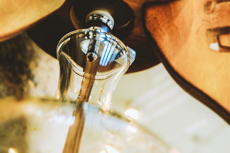 Close-up of drip brew coffee in glass bottleの写真素材