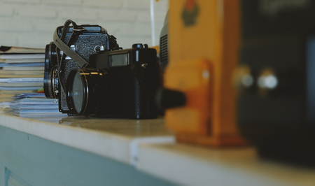 Classic camera on the table near a magazineの写真素材