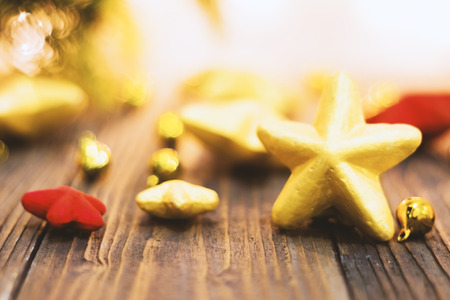 Soft focused on Gold Christmas star  placed on wooden floor ,prepare for Christmas partyの写真素材