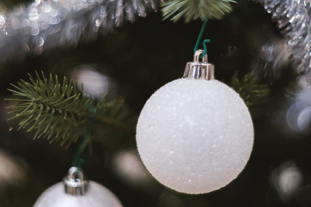 Soft focused on white  ball Christmas celebration accessories on Christmas tree prepare for the Christmas and happy New Year festivalの写真素材