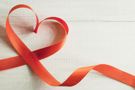Red ribbon on wooden background ,Valentines day background or Wedding day partyの写真素材