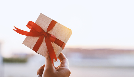 Womens  shown gift box to the evening sky with  her hands,Gift for lover or important personの写真素材