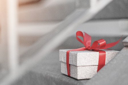 Glitter silver gift box with red ribbon on steel step ,Valentines day celebration seasonal for loversの写真素材