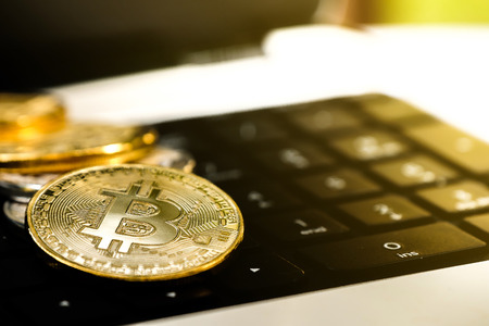 Golden Bit coins place on Laptop keyboard