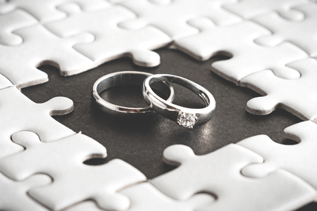 Wedding rings appear on blank space of jigsaw puzzle,two heart ,soul mate born to living togetherの写真素材
