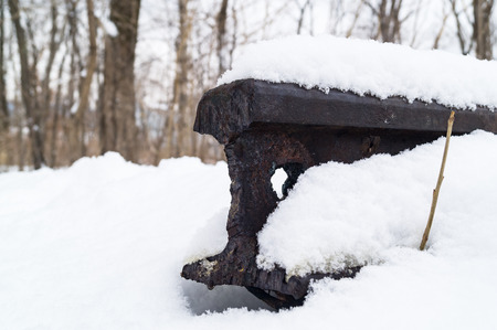 Cut rusty rail under snow in winter on an abandoned old railway in the forest. There is no way, the road is over, the road is destroyedの写真素材