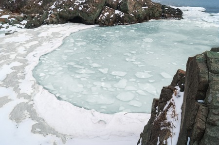 Ice floes float in the sea water in spring in the bay