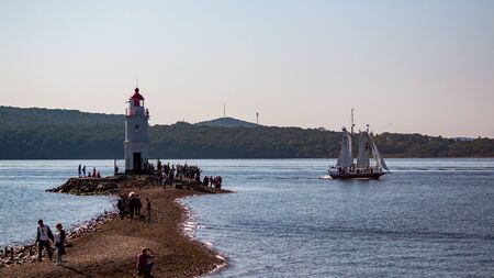 VLADIVOSTOK, RUSSIA - SEPTEMBER 11, 2018: The movement of ships in the Amur Bay of the Bosporus Vostochny strait in the background of the Russian Island during the preparation for the sailing regatta.のeditorial素材