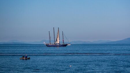 VLADIVOSTOK, RUSSIA - SEPTEMBER 11, 2018: The movement of ships in the Amur Bay of the Bosporus Vostochny strait in the background of the Russian Island during the preparation for the sailing regatta.のeditorial素材