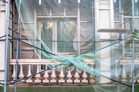 Construction site restoration work on the renovation of the old facade of the building of Soviet times.の写真素材