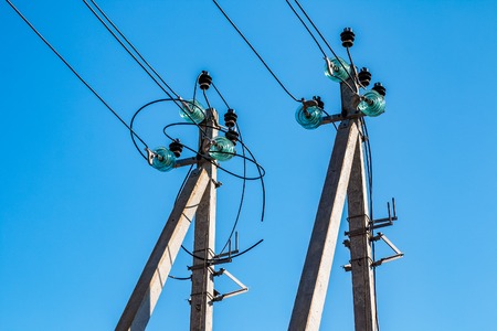 Concrete poles with electrical wires and high-voltage distribution insulators as part of a...