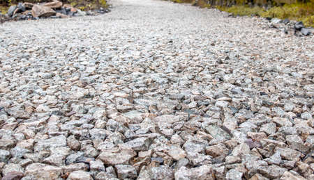 Background of gray stones at a road repair construction site as a drainage layer for paving asphaltの写真素材