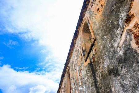Low angle image old external brick wall of the ruin of st paul church in malacca malaysia. Blue sky in visibility. Focus selective on old wallの写真素材