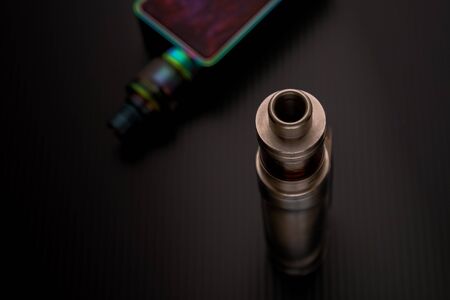 Conceptual of recent uncertainty of health safety of e-cigarette. Isolated close-up of atomizer...