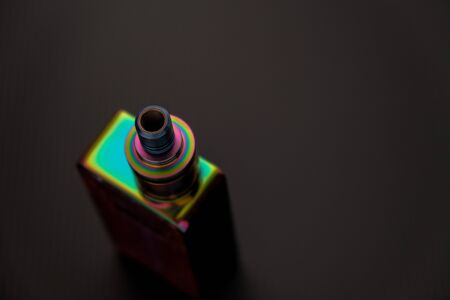 Conceptual of recent uncertainty of health safety of e-cigarette. Isolated close-up of atomizer attached to mouthpiece and battery overの写真素材