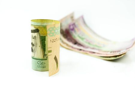 Image of saudi riyal banknotes in SR1, SR5, SR50, SR100 denomination over white. Focus on banknotes.の写真素材