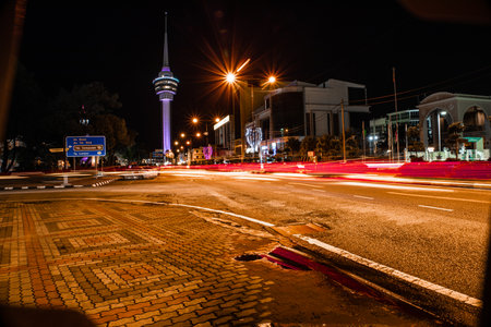 Kuantan, Malaysia - November 14, 2022: Light trails of vehicles in movement on the road with background Kuantan 188 tower.のeditorial素材