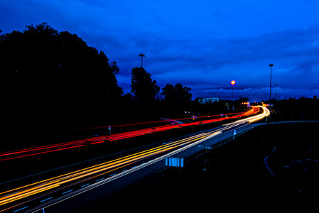 Light trails of the vehicles speeding in movement on the Highway