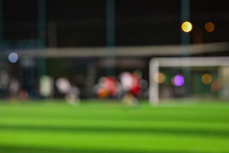 Blur of football or soccer field at night with bokehの写真素材