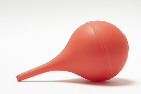 Medical enema orange on a white backgroundの写真素材